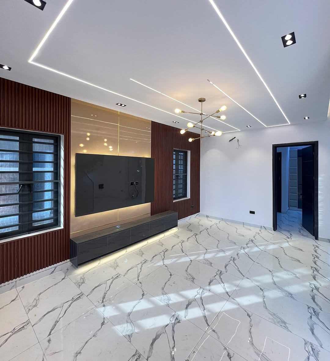 Luxury living room with layered lighting and sculptural furnishings
